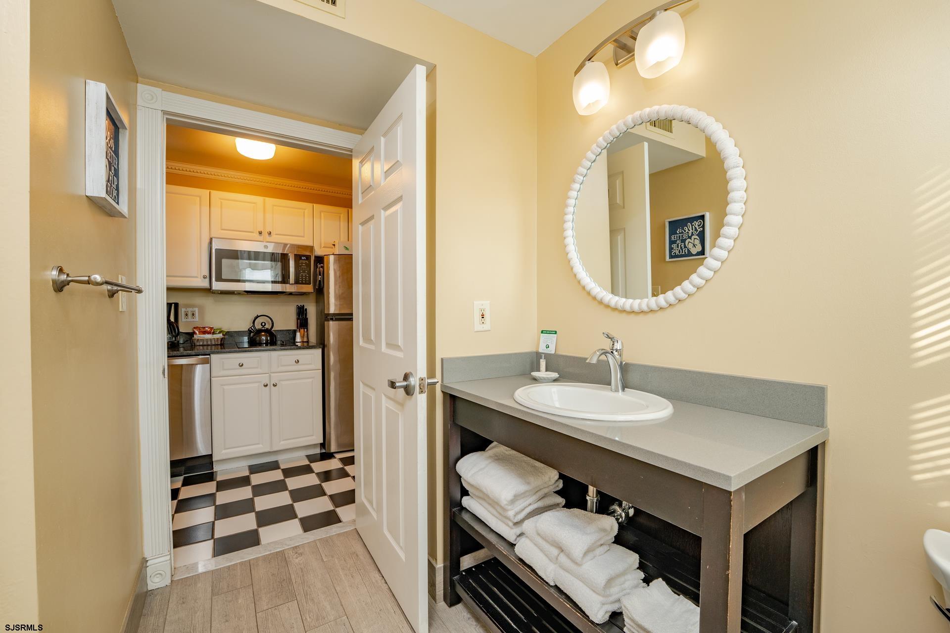719 East 11th Street, Unit 510 Ocean City, NJ 08226 - Photo 15 of 16 a en suite bathroom with a sink and a mirror