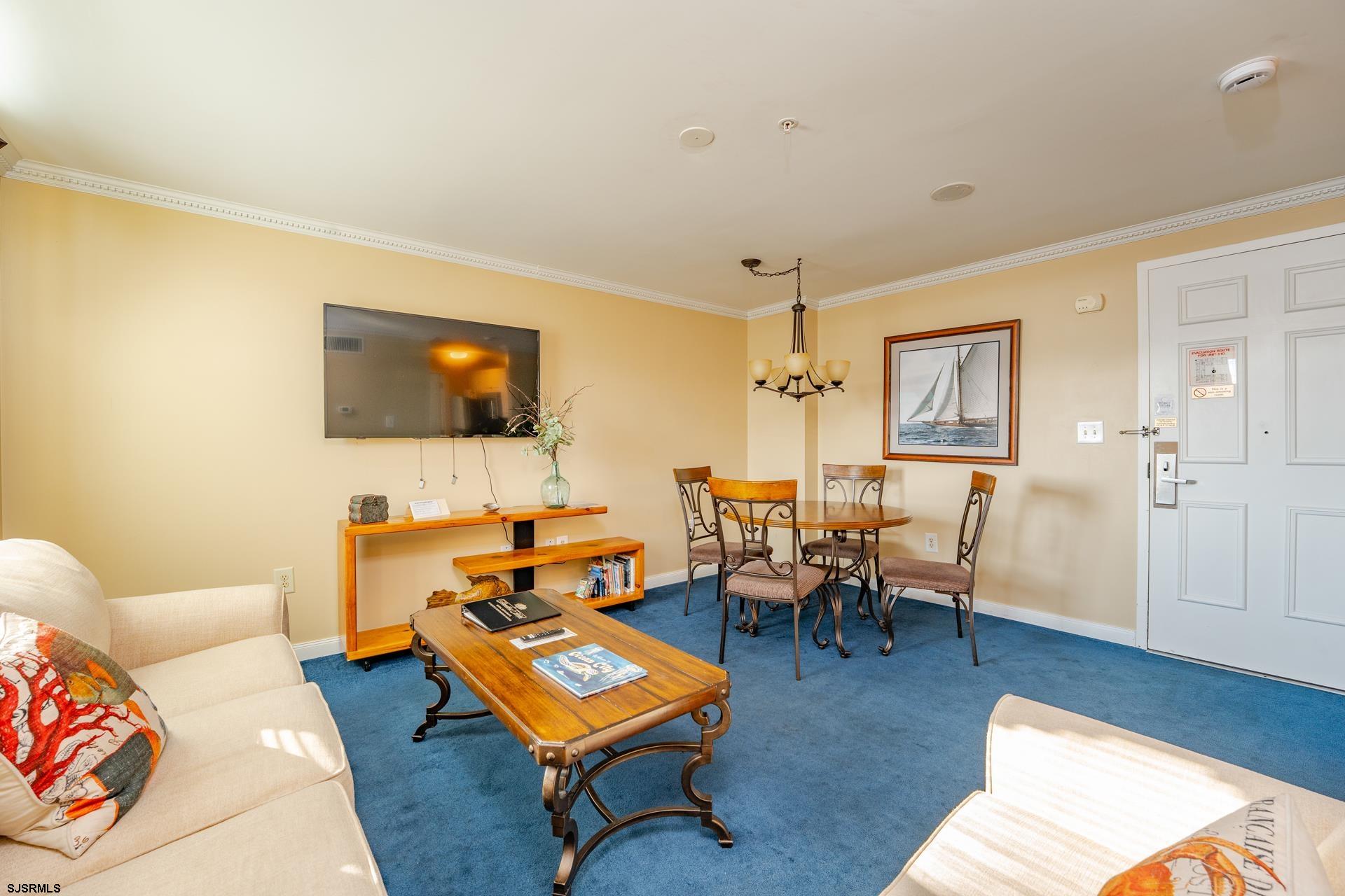 719 East 11th Street, Unit 510 Ocean City, NJ 08226 - Photo 7 of 16 a living room with furniture and a flat screen tv