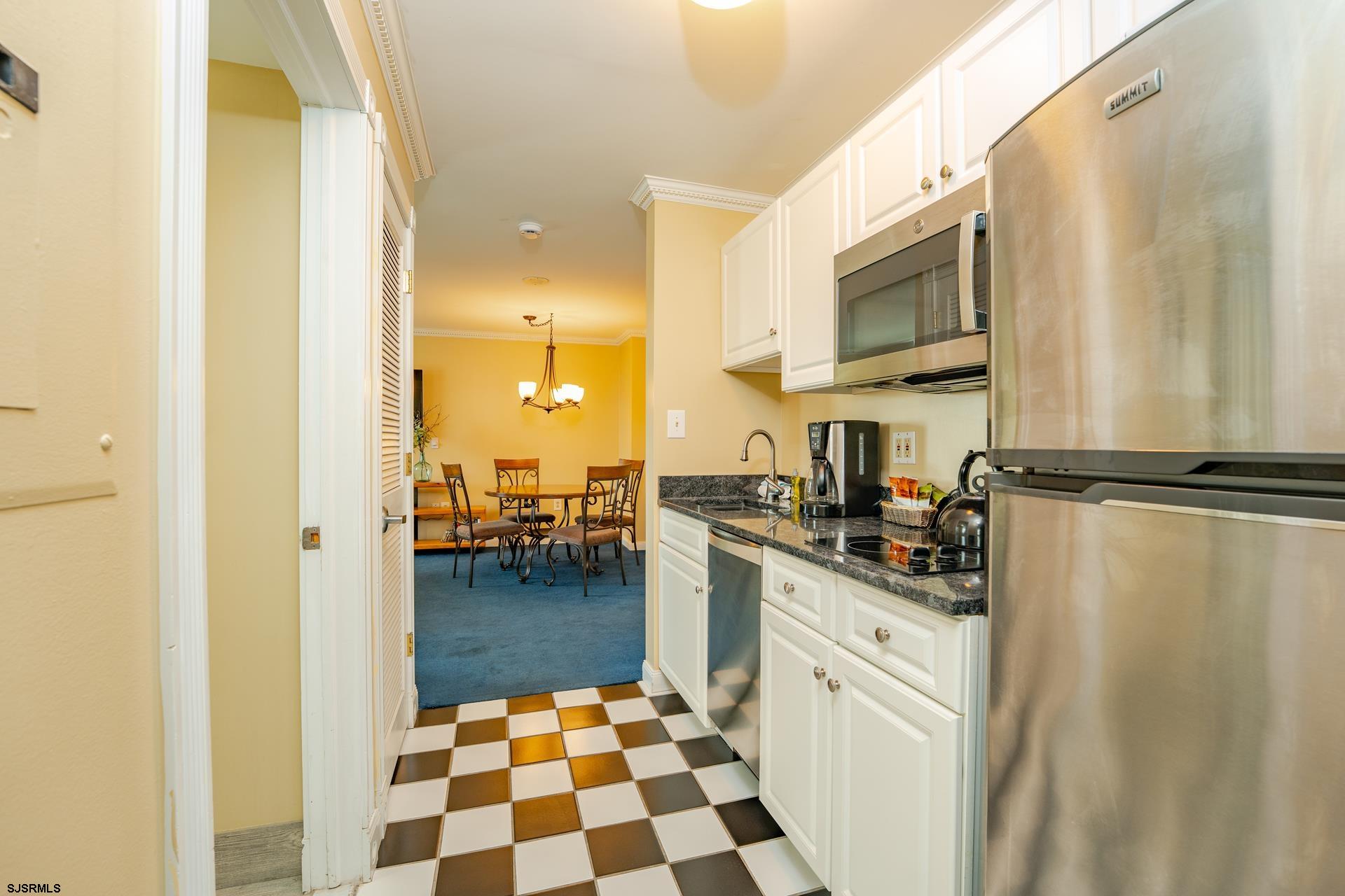 719 East 11th Street, Unit 510 Ocean City, NJ 08226 - Photo 10 of 16 a kitchen with stainless steel appliances granite countertop a refrigerator and a stove