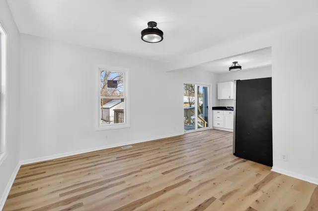 a view of empty room with wooden floor