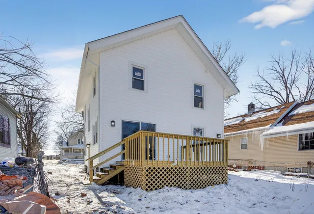 a view of a wooden house with a yard