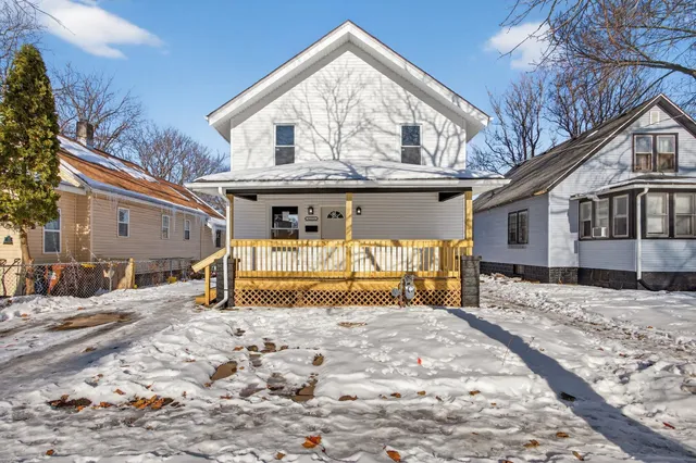 a view of a house with a snow in the yard