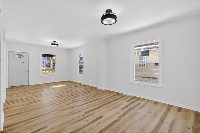 an empty room with a empty space and windows