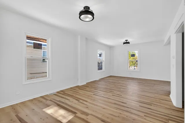 an empty room with windows and closet