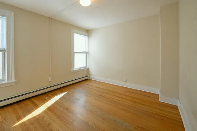 a view of room with window and wooden floor