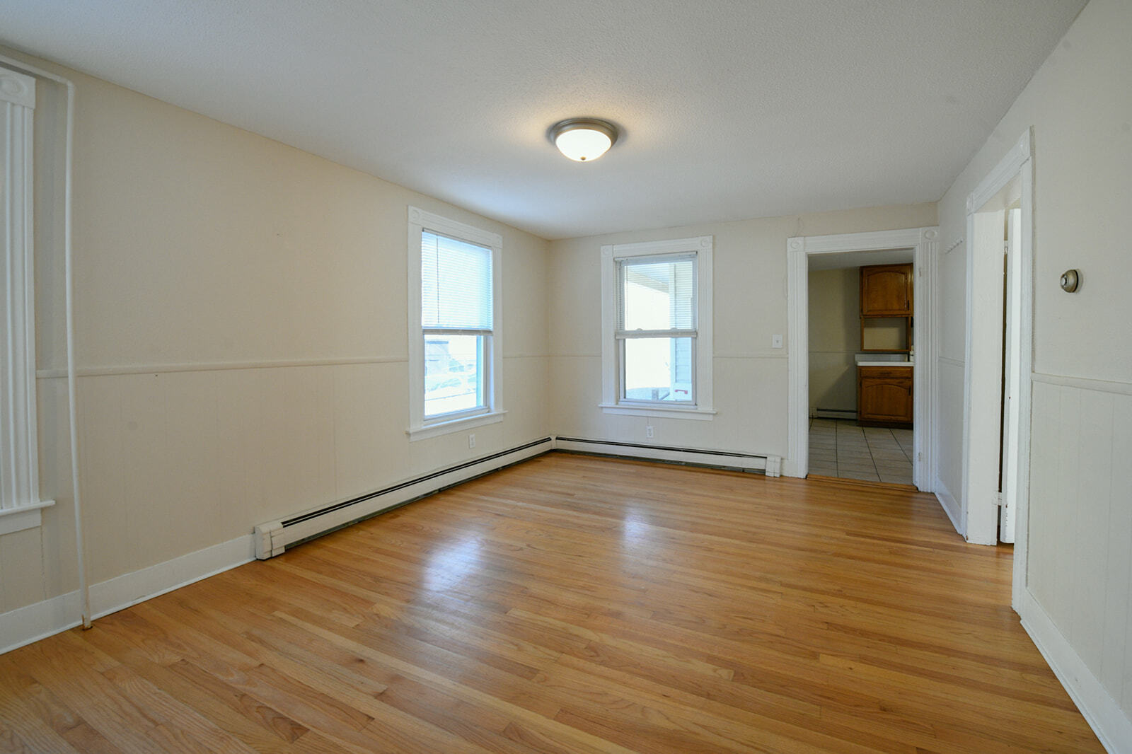 63 New Britain Avenue, Unit 1 Farmington, CT 06085 - Photo 14 of 25 an empty room with wooden floor and windows