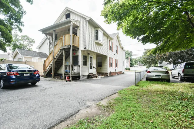 a view of a parked cars in front of a house