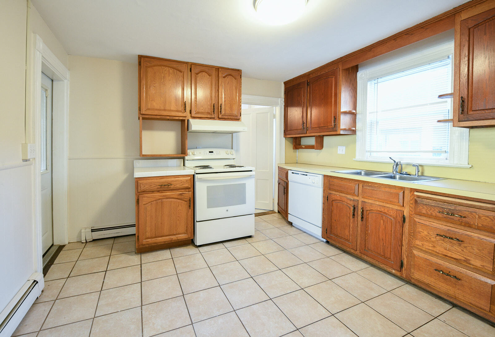 63 New Britain Avenue, Unit 1 Farmington, CT 06085 - Photo 6 of 25 a kitchen with a stove sink and cabinets