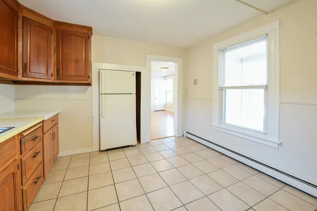 a view of a kitchen with white cabinets