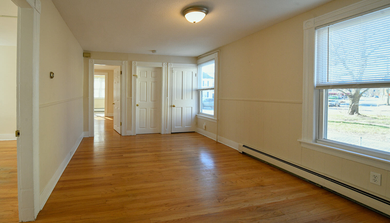 63 New Britain Avenue, Unit 1 Farmington, CT 06085 - Photo 9 of 25 a view of an empty room with wooden floor and a window