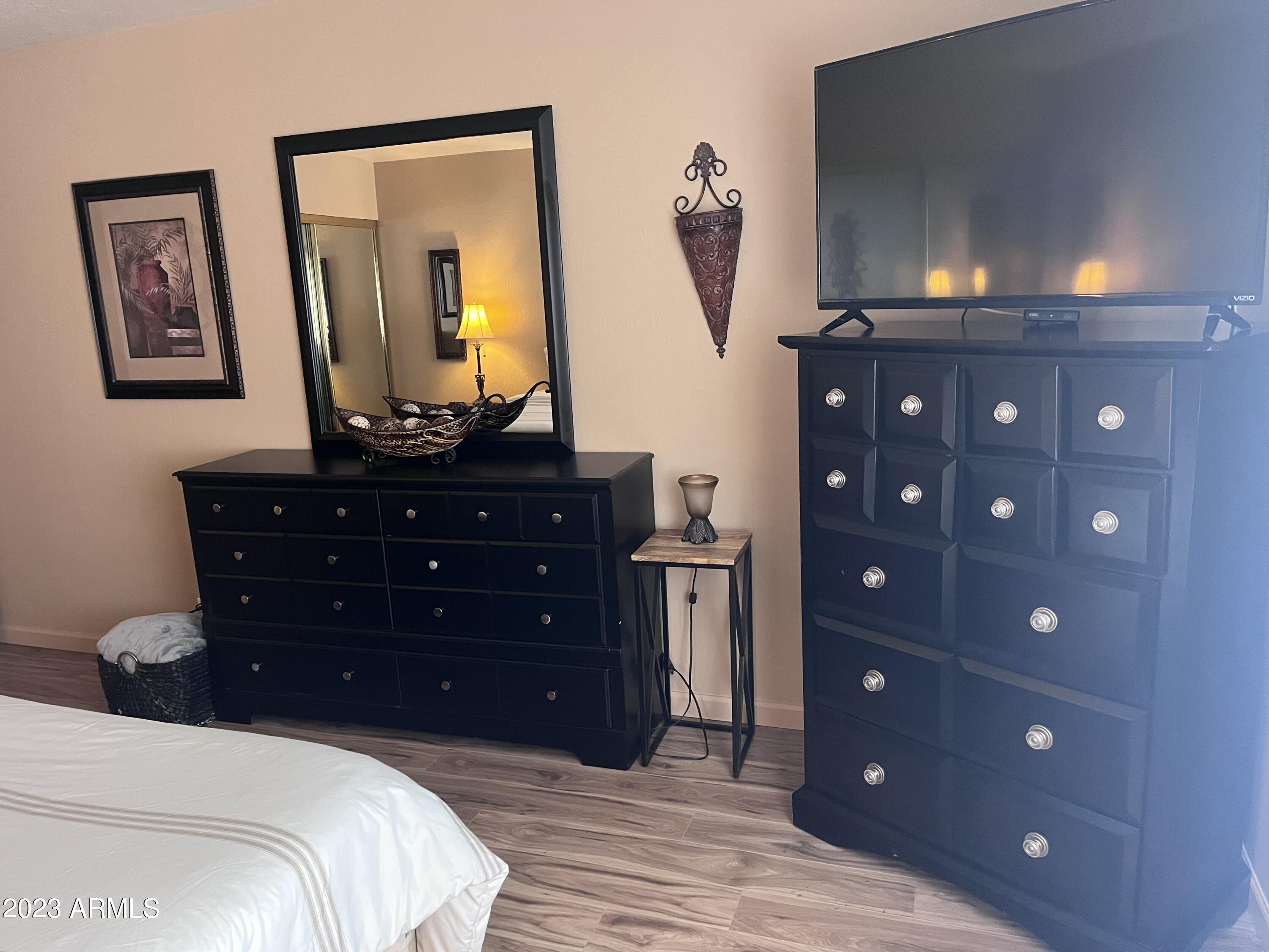 4600 North 68th Street, Unit 356 Scottsdale, AZ 85251 - Photo 12 of 16 a bedroom with a bed and a dresser