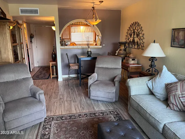 a living room with furniture and a wooden floor