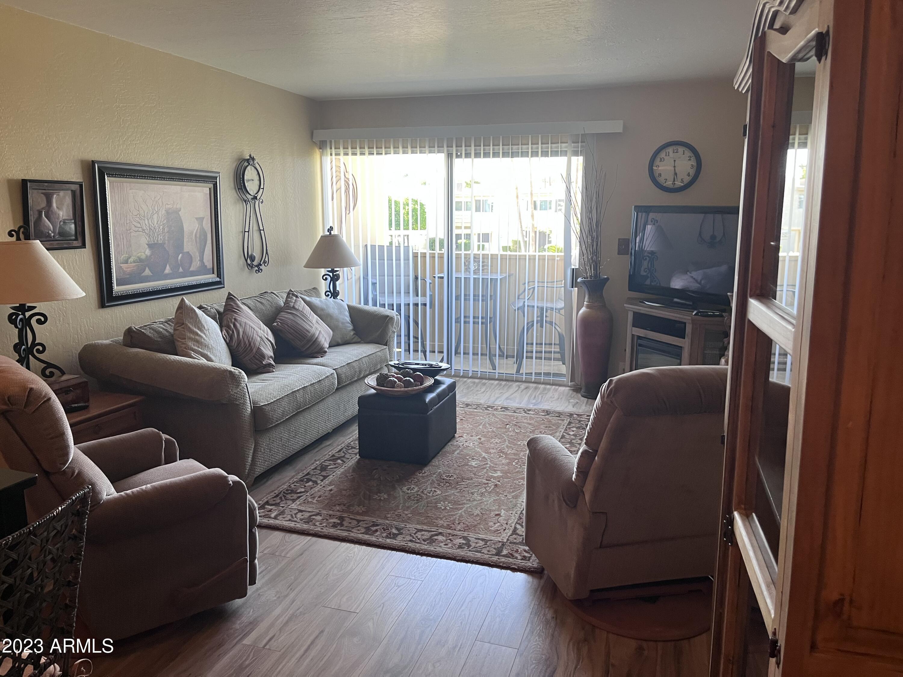 4600 North 68th Street, Unit 356 Scottsdale, AZ 85251 - Photo 4 of 16 a living room with furniture and a large window