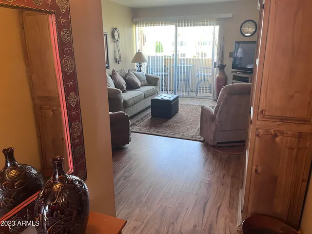 a living room with furniture and a floor to ceiling window