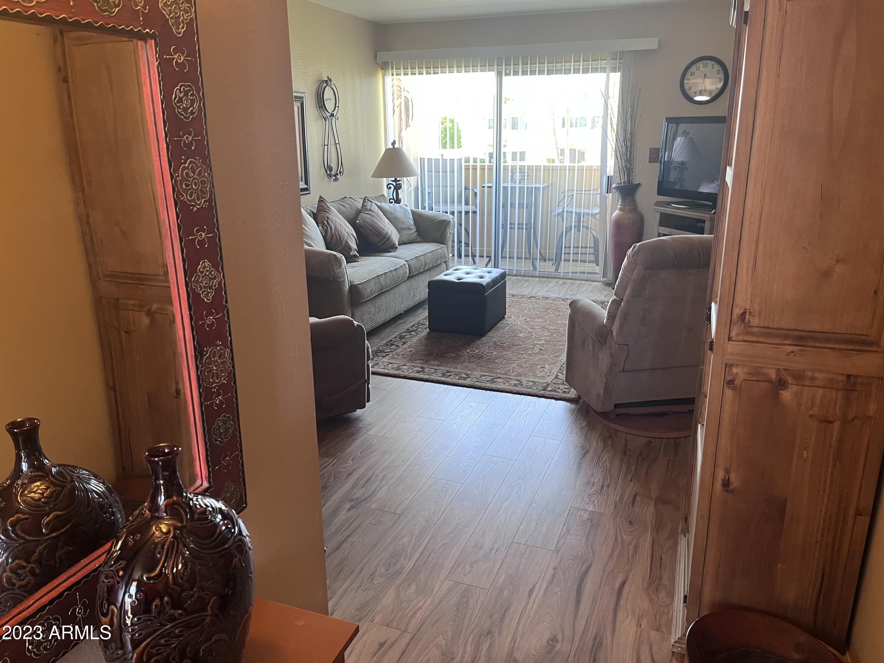 4600 North 68th Street, Unit 356 Scottsdale, AZ 85251 - Photo 6 of 16 a living room with furniture and a floor to ceiling window