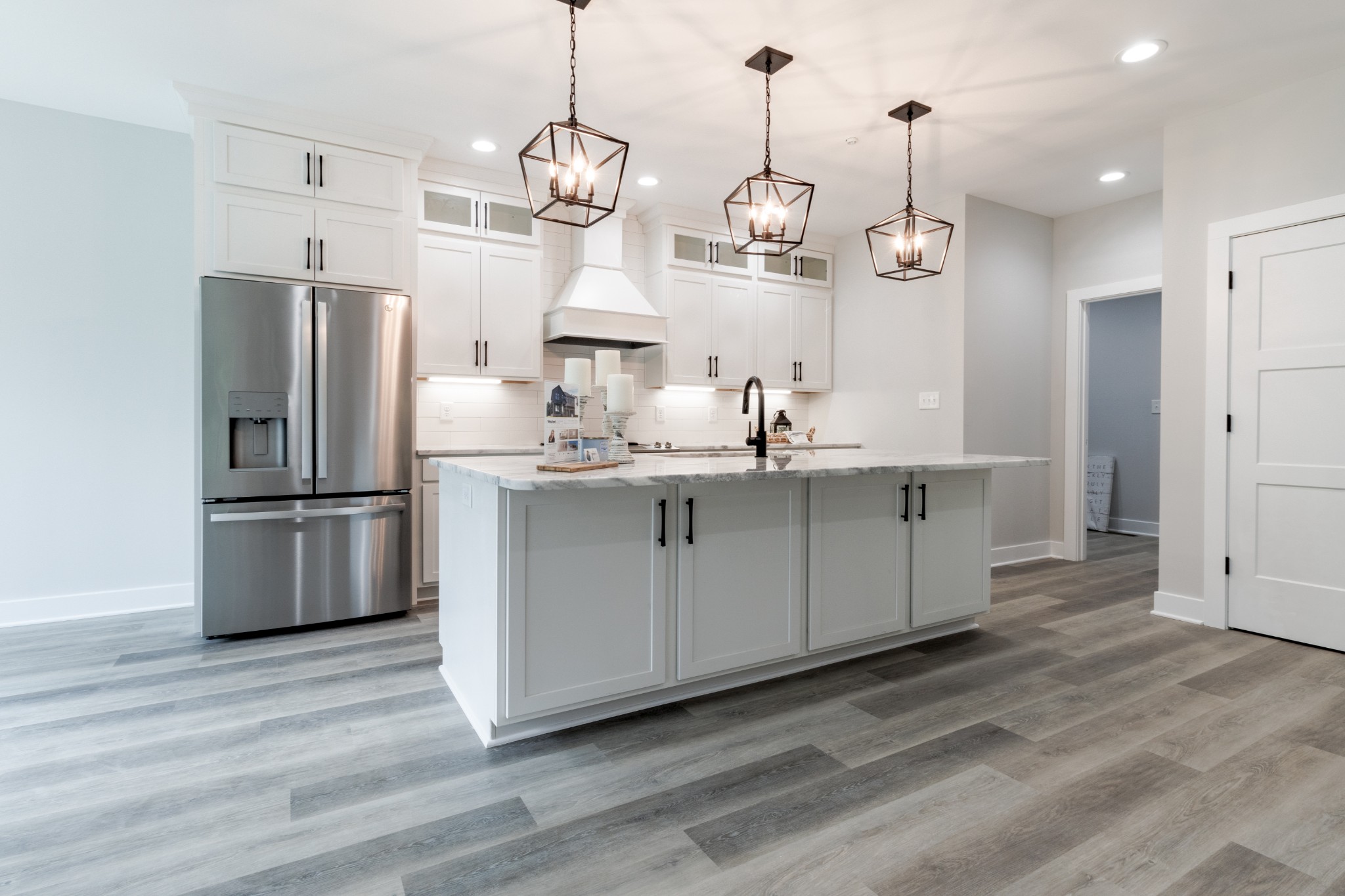 199 Gower Street Pleasant View, TN 37146 - Photo 14 of 38 a kitchen with kitchen island white cabinets and stainless steel appliances