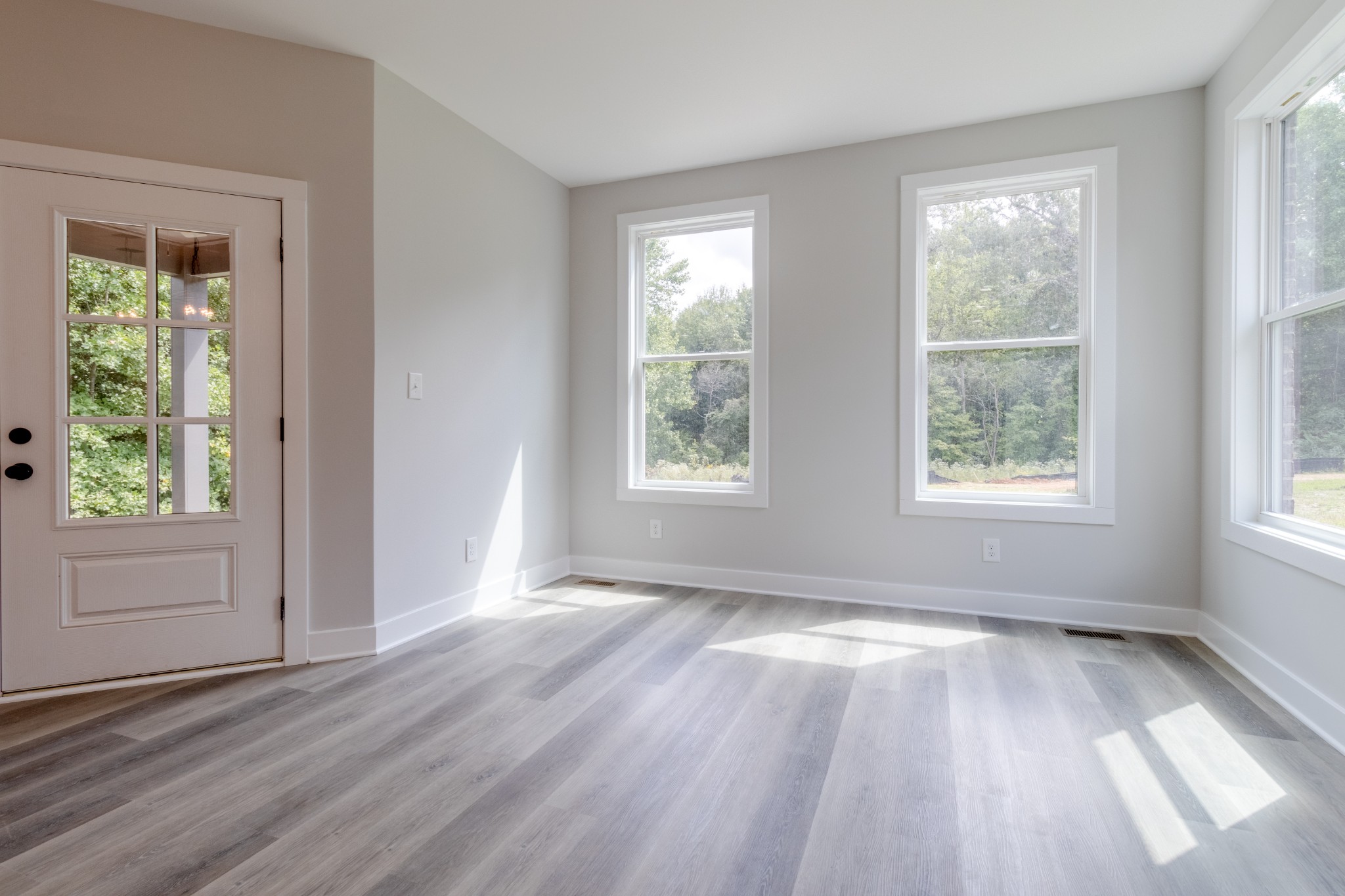 199 Gower Street Pleasant View, TN 37146 - Photo 16 of 38 a view of an empty room with wooden floor and a window