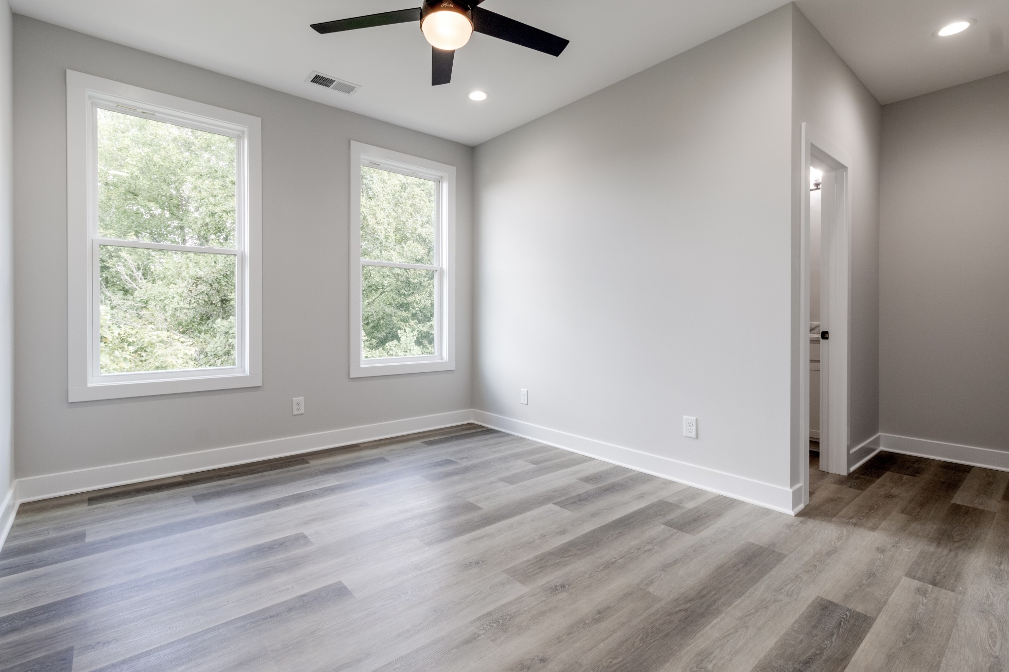 199 Gower Street Pleasant View, TN 37146 - Photo 26 of 38 a view of an empty room with wooden floor and a window