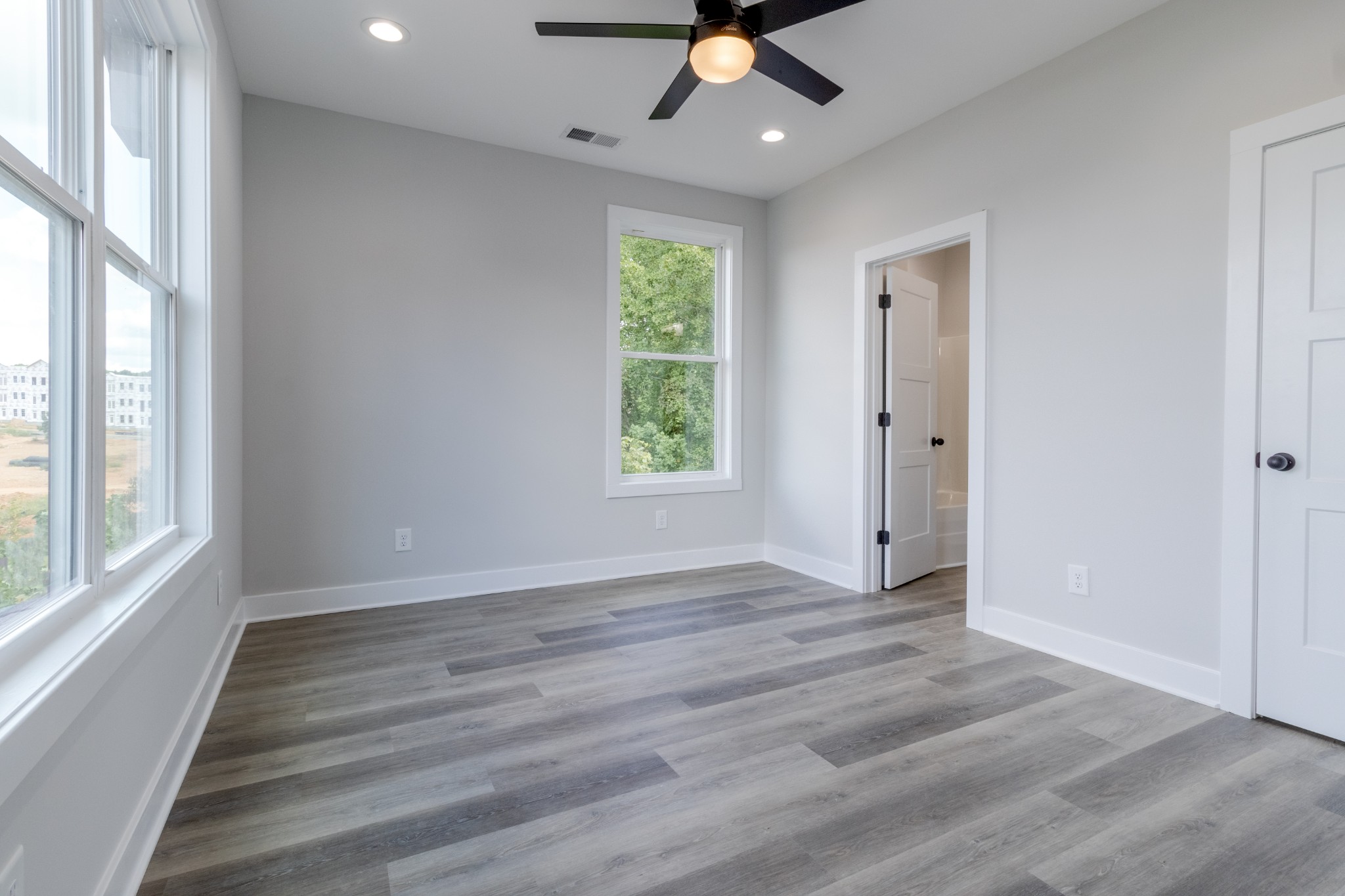 199 Gower Street Pleasant View, TN 37146 - Photo 28 of 38 a view of an empty room with wooden floor and a window