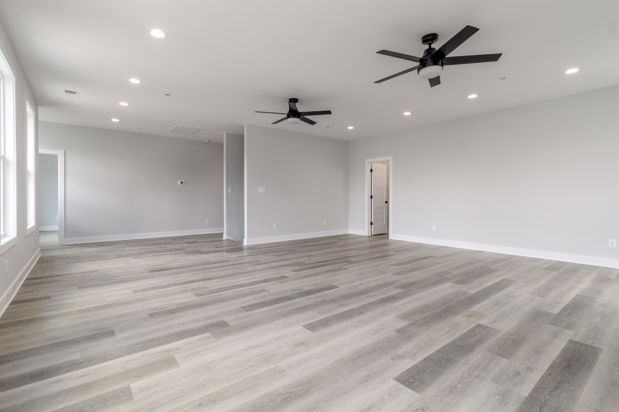 199 Gower Street Pleasant View, TN 37146 - Photo 31 of 38 an empty room with wooden floor and ceiling fan