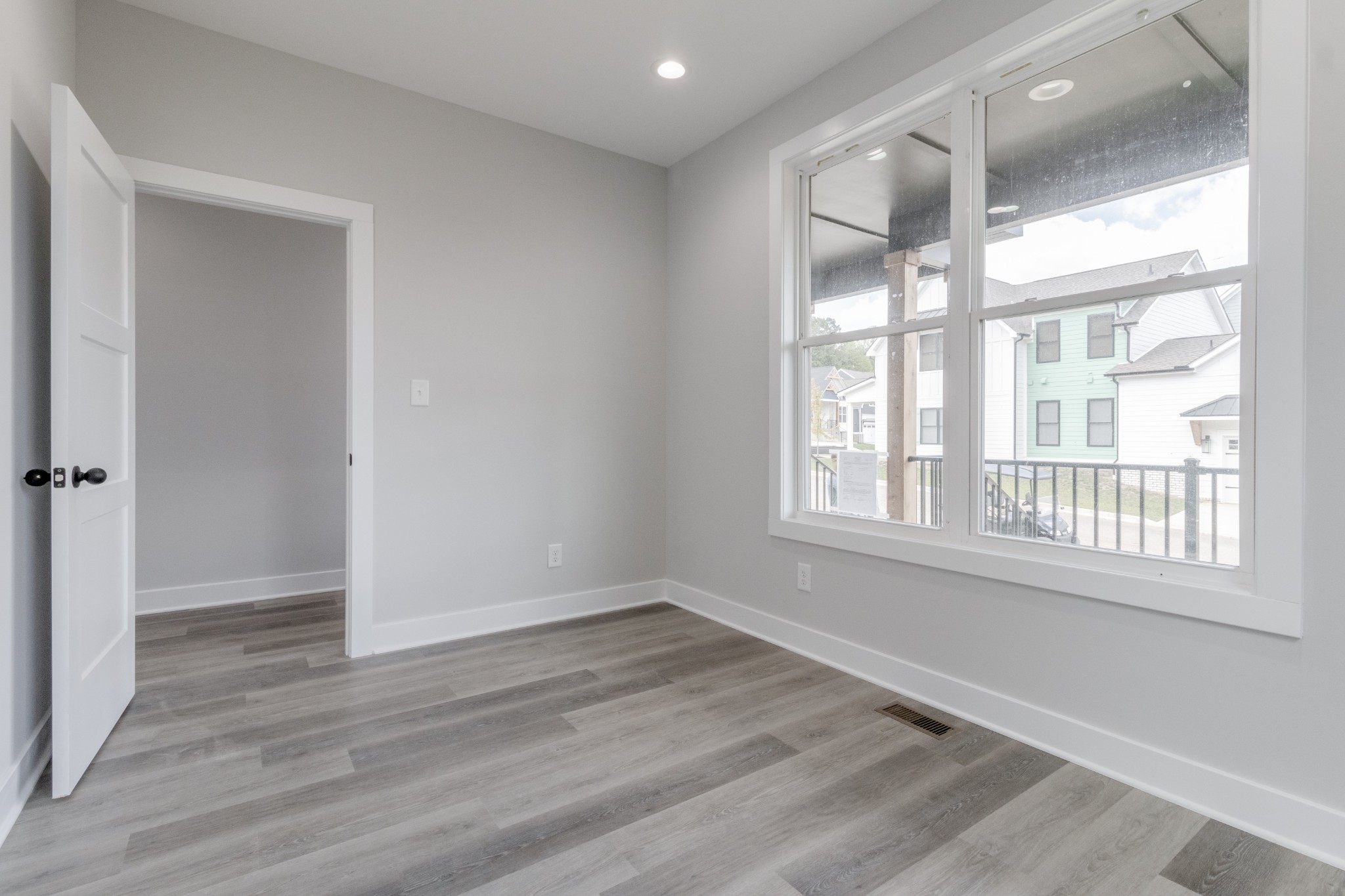 199 Gower Street Pleasant View, TN 37146 - Photo 8 of 38 a view of an empty room with wooden floor and a window