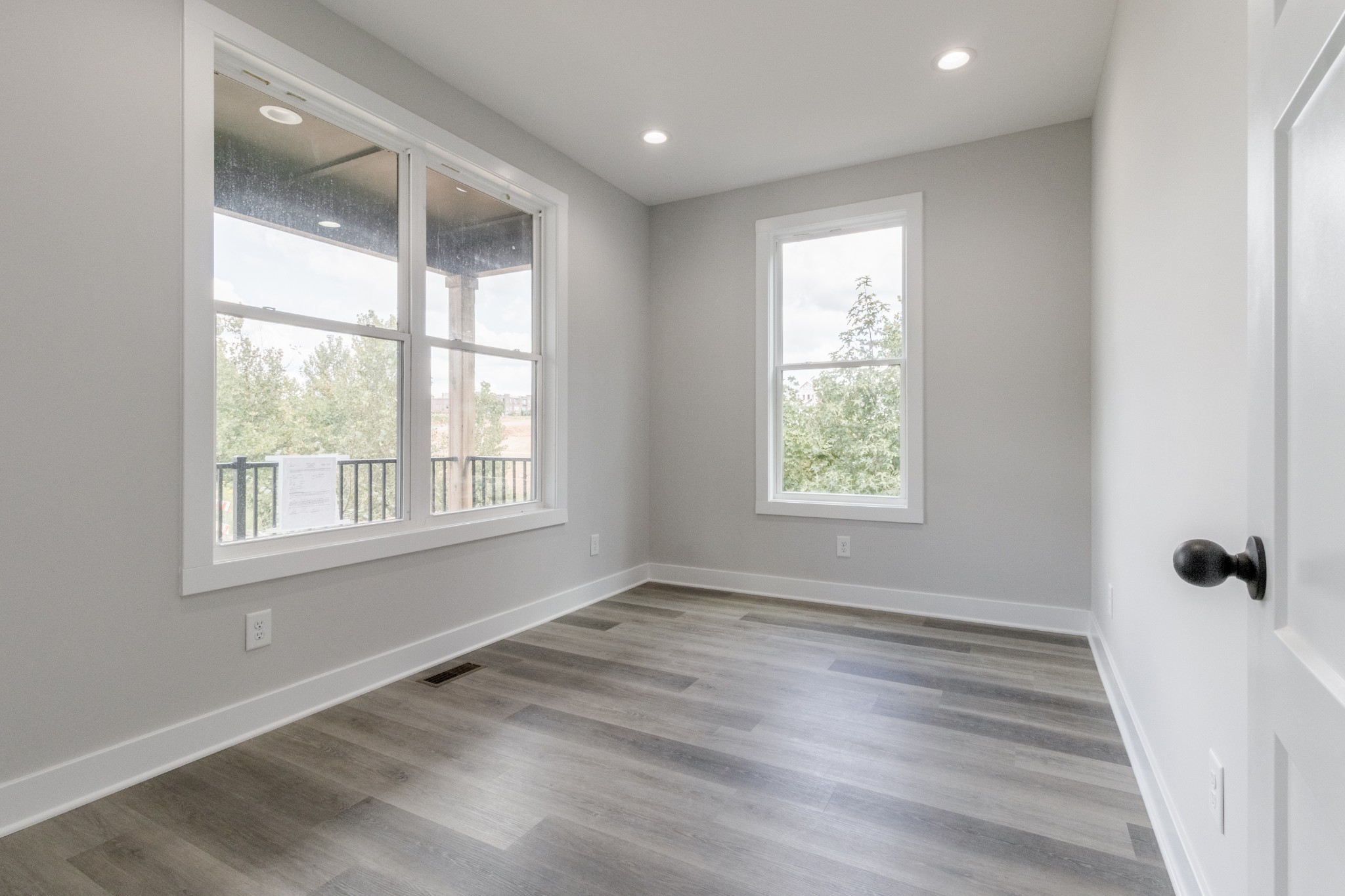 199 Gower Street Pleasant View, TN 37146 - Photo 9 of 38 a view of an empty room with wooden floor and a window