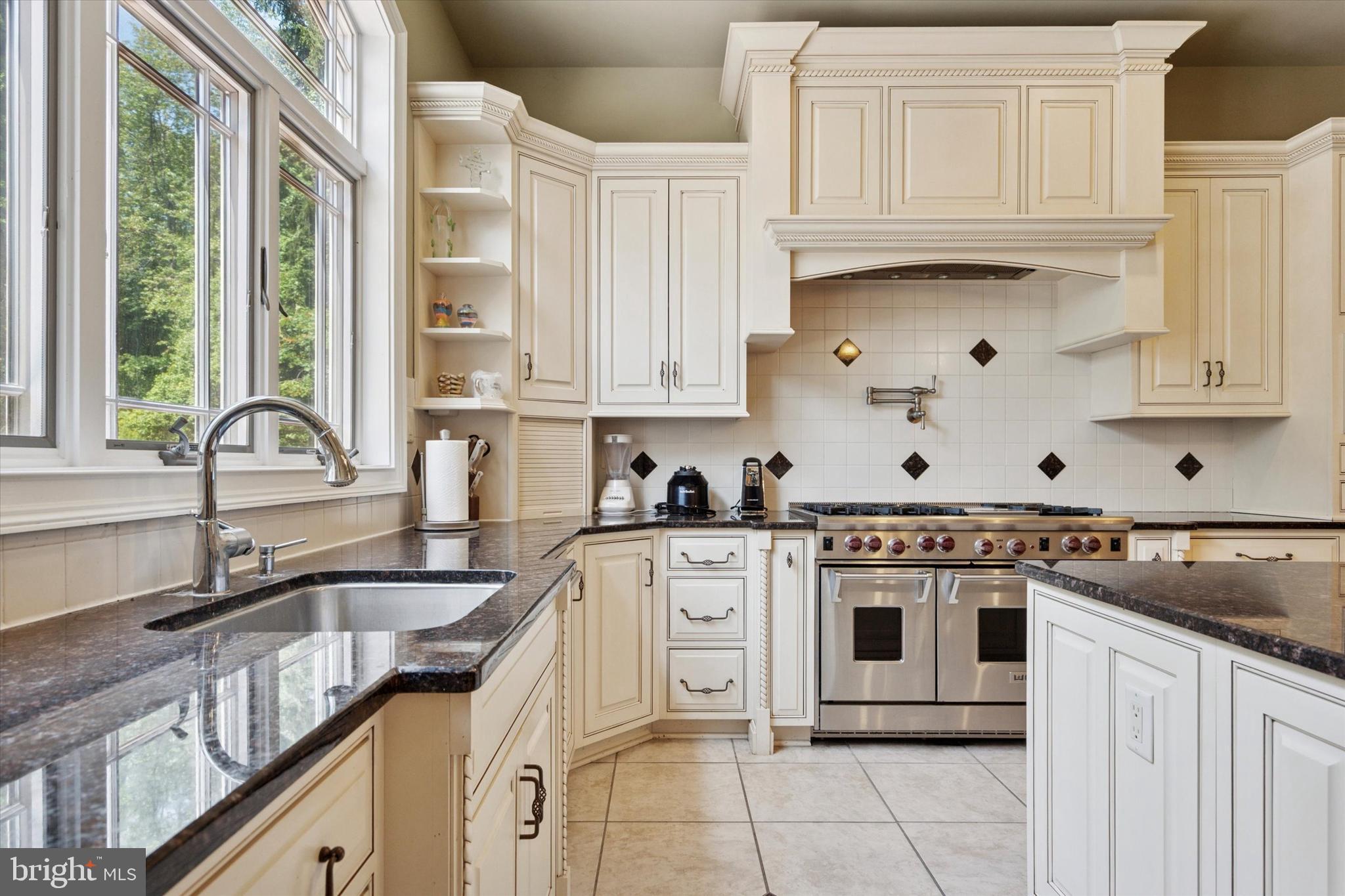 1514 Cherry Lane Rydal, PA 19046 - Photo 15 of 50 a kitchen with stainless steel appliances granite countertop a stove sink and cabinets