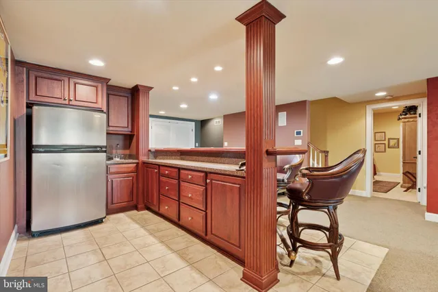 a living room with furniture a lamp and a flat screen tv