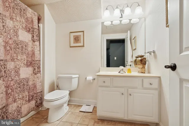 a kitchen with stainless steel appliances kitchen island granite countertop a sink and a refrigerator