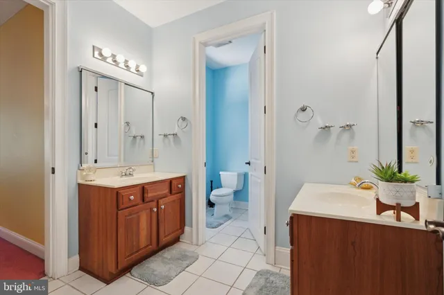 a spacious bedroom with a bed and a chandelier