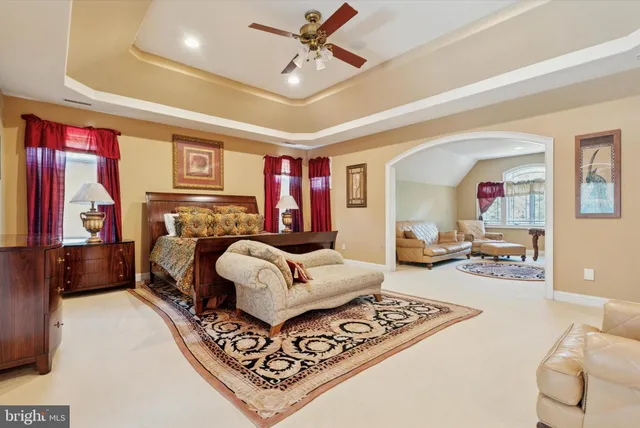 a bedroom with a large bed and a chandelier