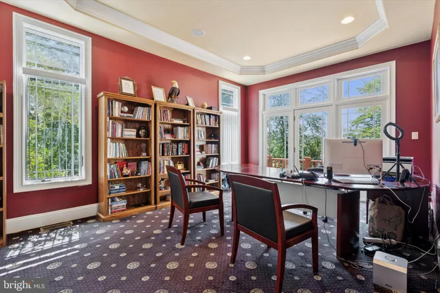 a view of a workspace with furniture and a window