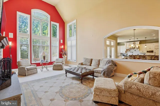 a living room with furniture and large windows