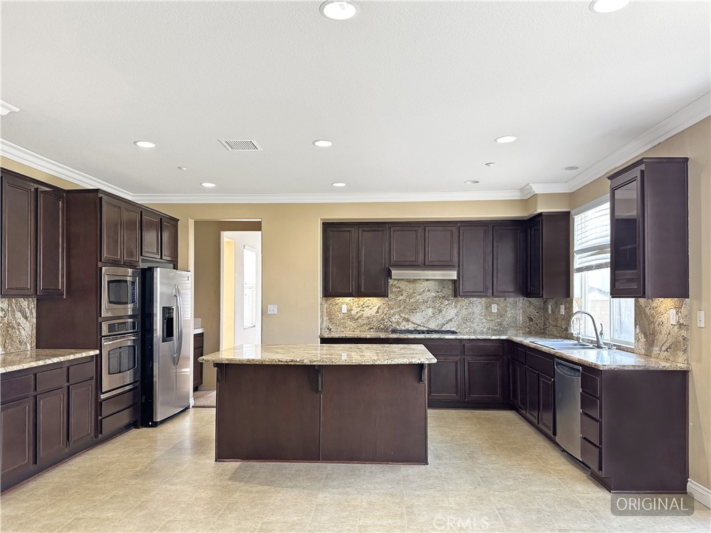9549 Calico Trail Riverside, CA 92508 - Photo 17 of 46 a kitchen with stainless steel appliances granite countertop a refrigerator and a stove top oven