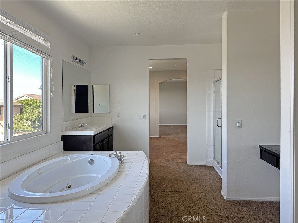 9549 Calico Trail Riverside, CA 92508 - Photo 27 of 46 a bathroom with a tub sink and mirror