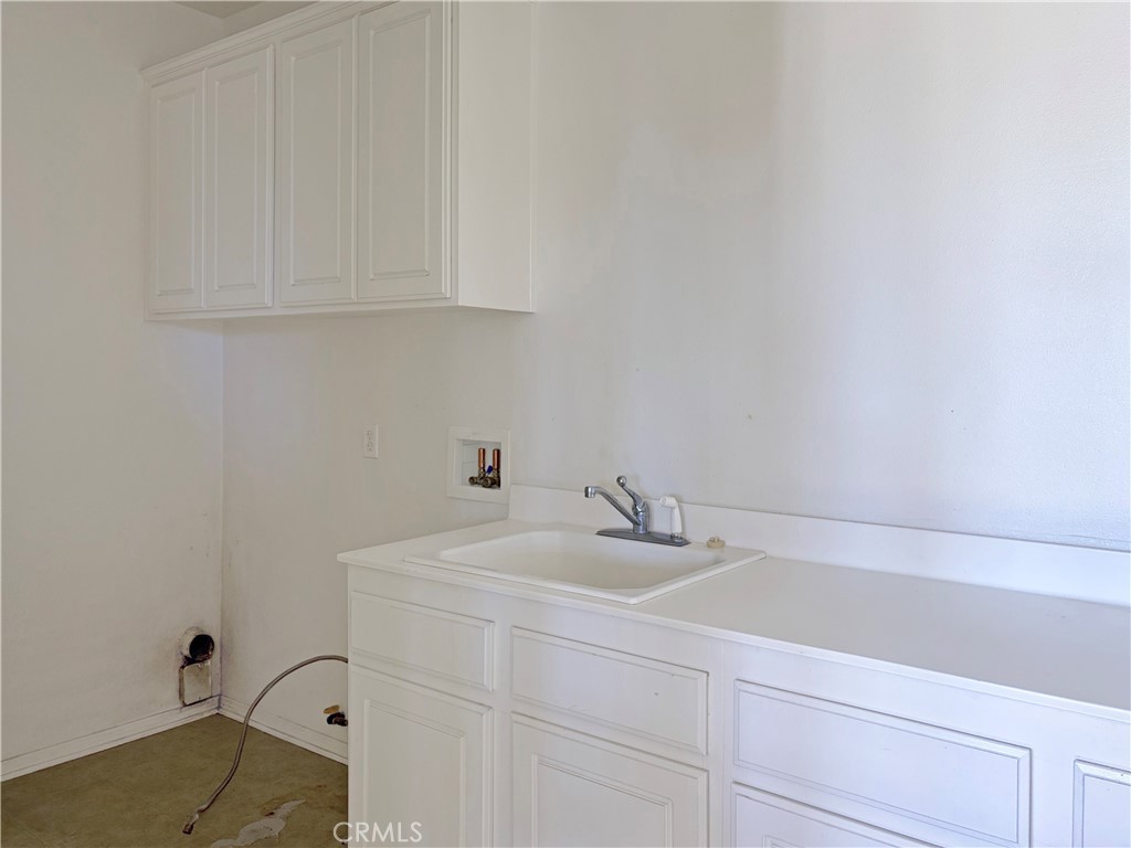 9549 Calico Trail Riverside, CA 92508 - Photo 28 of 46 a bathroom with a sink and cabinets