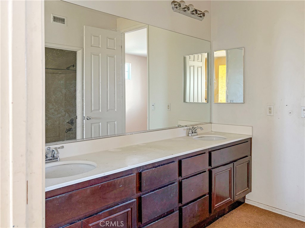 9549 Calico Trail Riverside, CA 92508 - Photo 30 of 46 a bathroom with a sink and a mirror