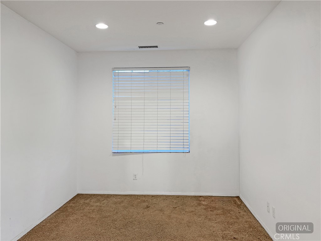 9549 Calico Trail Riverside, CA 92508 - Photo 8 of 46 an empty room with wooden floor and windows