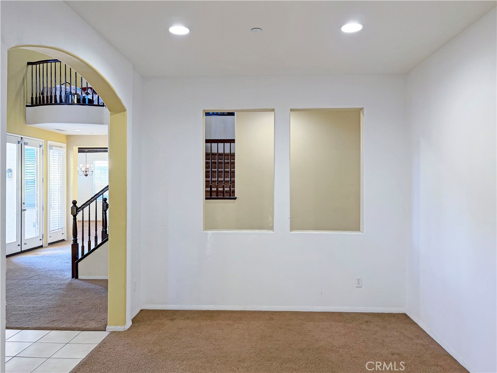 9549 Calico Trail Riverside, CA 92508 - Photo 9 of 46 an empty room with wooden floor and windows