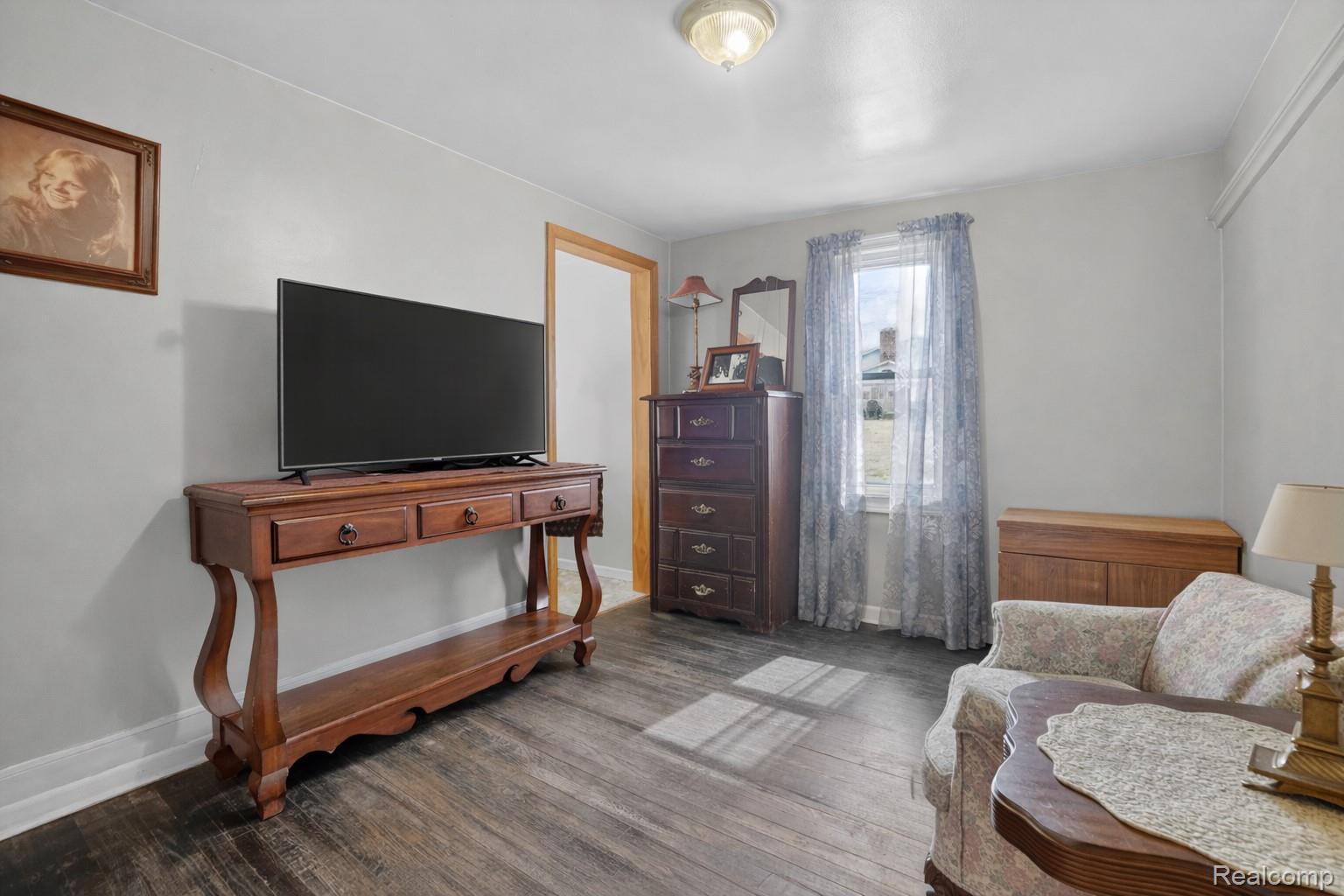 13343 Fenton Road Fenton, MI 48430 - Photo 29 of 45 Living area featuring wood finished floors and baseboards