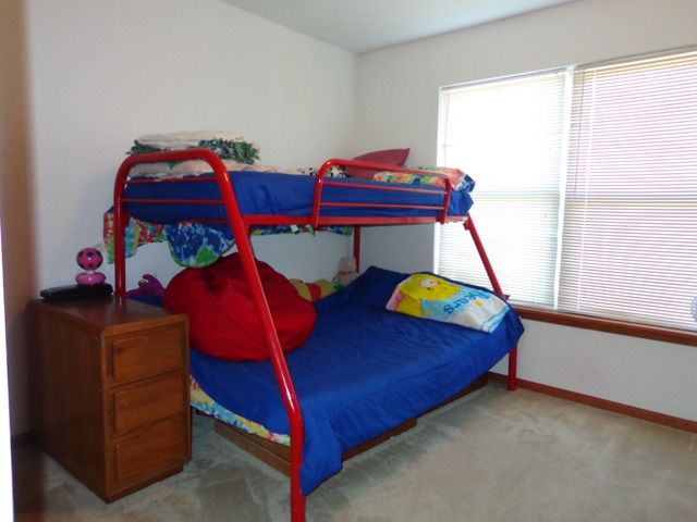 2217 Ashby Lane Plainfield, IL 60586 - Photo 12 of 20 a bedroom with two beds and a window