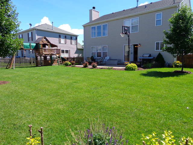 2217 Ashby Lane Plainfield, IL 60586 - Photo 20 of 20 a front view of a house with a garden and outdoor seating