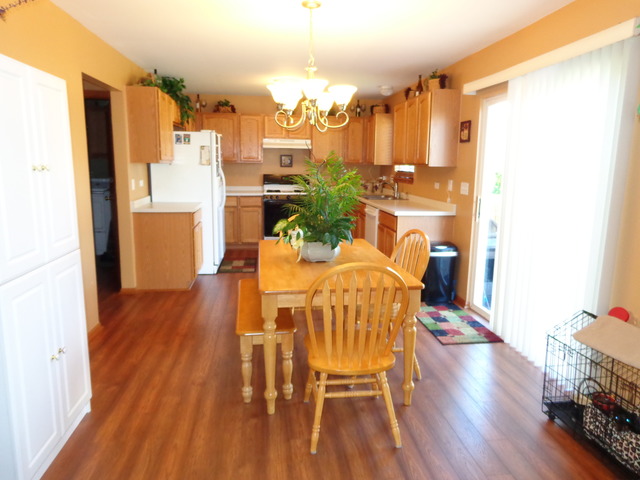 2217 Ashby Lane Plainfield, IL 60586 - Photo 6 of 20 a view of a dining room with furniture and wooden floor