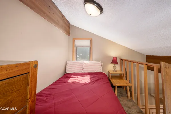 a bed room with a bed and a large window