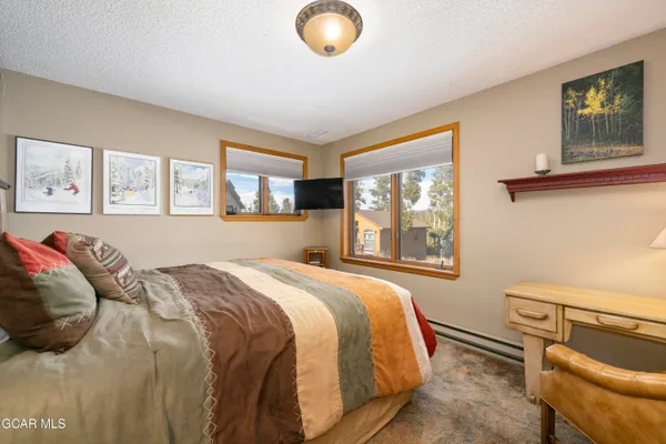 a bed sitting in a bedroom next to a window