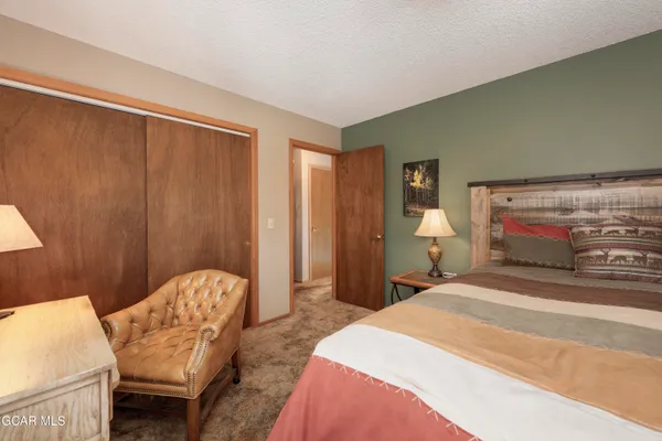 a bedroom with a bed and chair