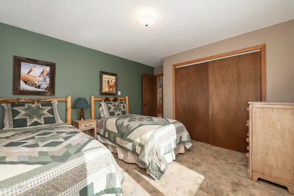 a bedroom with two beds and a large mirror