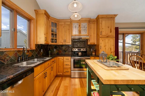 a kitchen with sink a stove and cabinets