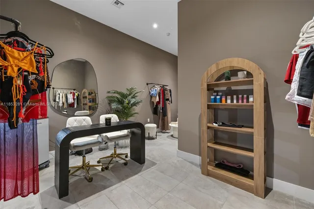 a living room with furniture a chandelier and a large window