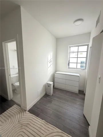 a bathroom with a sink a toilet and a window